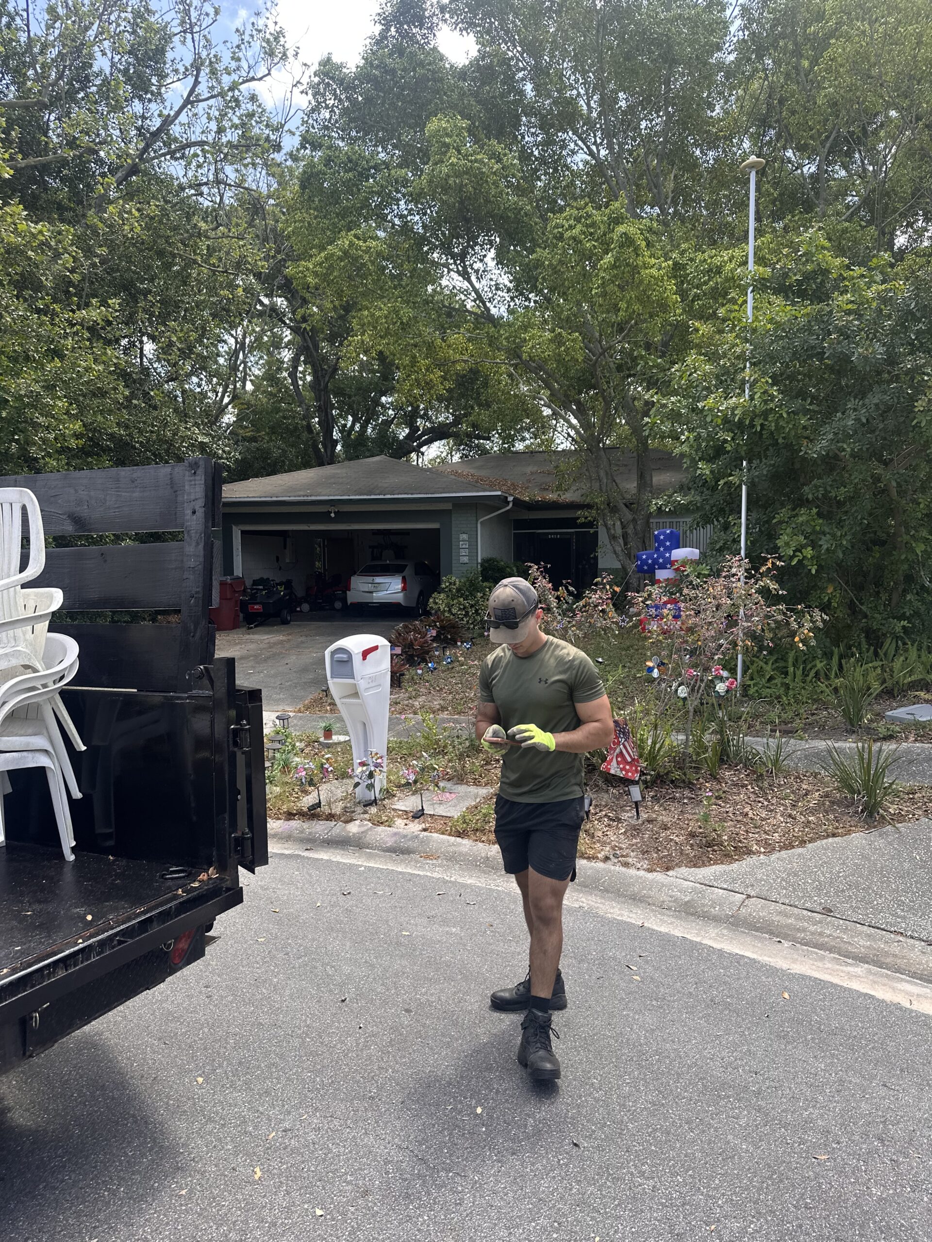 Junk Busters crew member beside a dump trailer during a Tampa Bay project