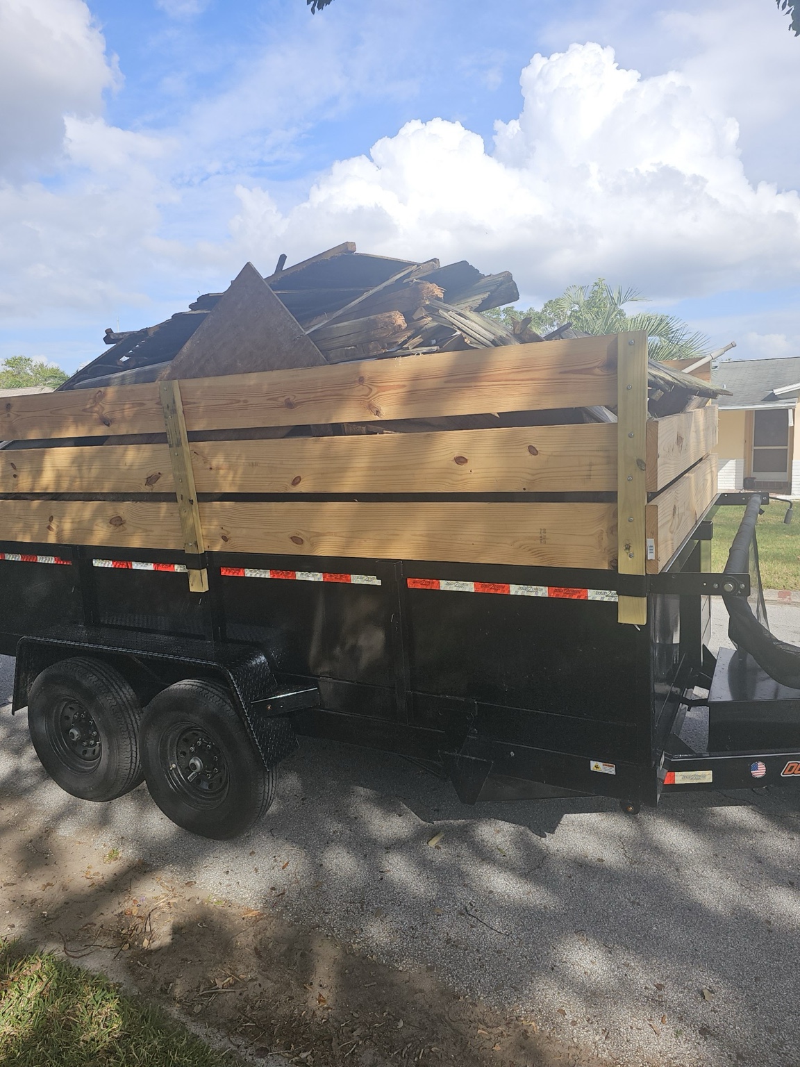 Junk Busters trailer loaded with wood and construction debris during a Tampa Bay cleanup